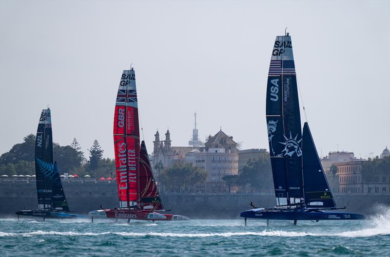 USA SailGP Team helmed by Jimmy Spithill ahead of Emirates Great Britain SailGP Team and New Zealand SailGP Team sail past the seawall during a practice session ahead of the Spain Sail Grand Prix in Cadiz, Spain photo copyright Bob Martin for SailGP taken at  and featuring the F50 class