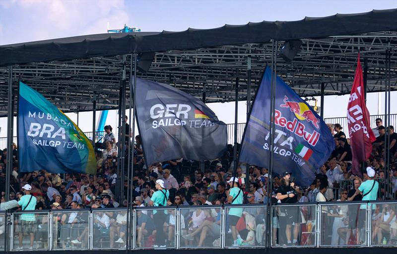 Spectators watch from the grandstand in the race stadium as team flags are paraded by on Race Day 1 of the Emirates Dubai Sail Grand Prix photo copyright Felix Diemer/SailGP taken at Dubai Offshore Sailing Club and featuring the F50 class