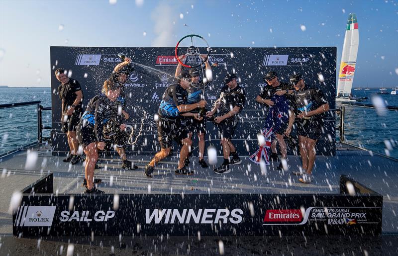 Peter Burling, co-CEO and driver of New Zealand SailGP Team on the podium as they spray rose water in celebration with the New Zealand SailGP Team on Race Day 2 of the Emirates Dubai Sail Grand Prix photo copyright Christopher Pike/SailGP taken at Dubai Offshore Sailing Club and featuring the F50 class