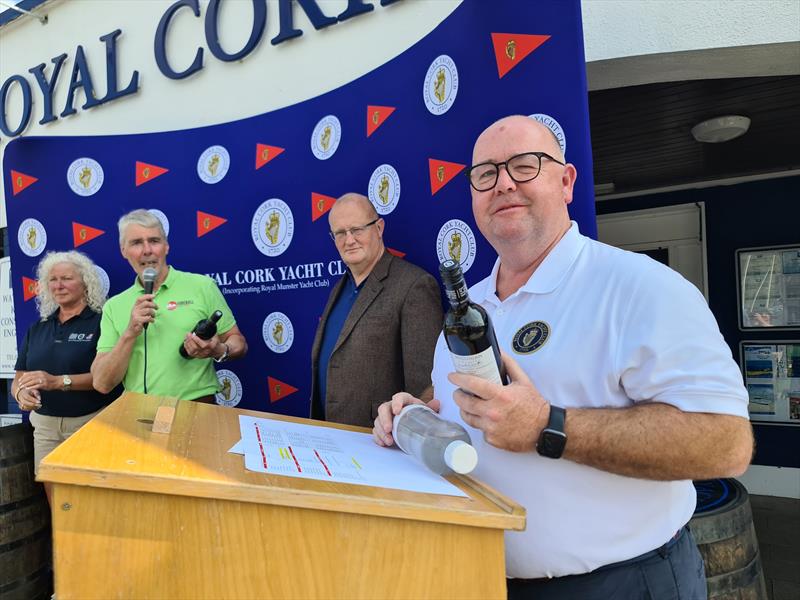 Main organiser Dominic Daly presented with wine by Irish Fireball Association chair Neil Cramer (left) during the Fireball Irish Nationals at Crosshaven photo copyright Frank Miller taken at Royal Cork Yacht Club and featuring the Fireball class