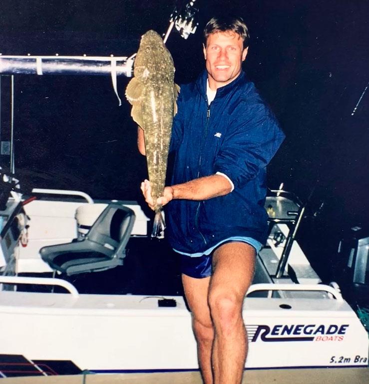 ET as a teenager standing on a wharf with my 5.2m white centre console tied up holding a flathead photo copyright Andrew Ettingshausen taken at  and featuring the Fishing boat class