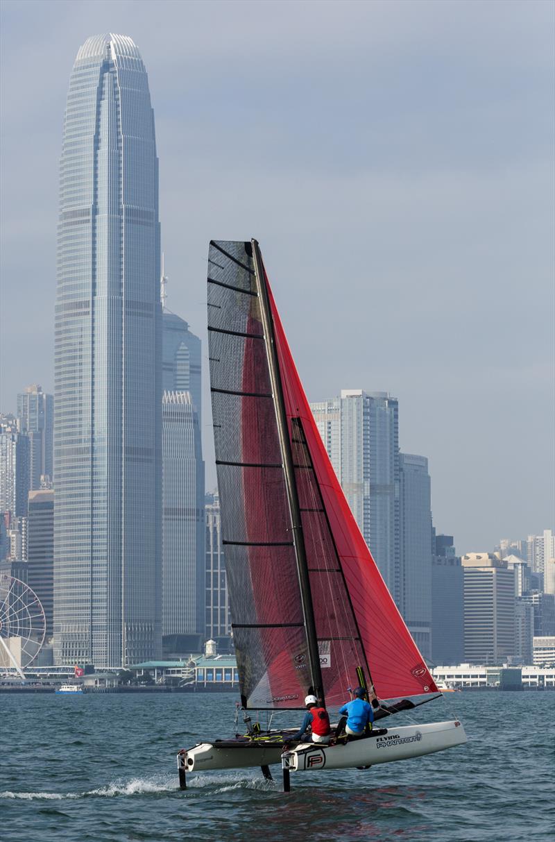 Cariad Trophy - Thornburrow and Partidge sailing under the skyscrapers of Central photo copyright Guy Nowell taken at  and featuring the Flying Phantom class