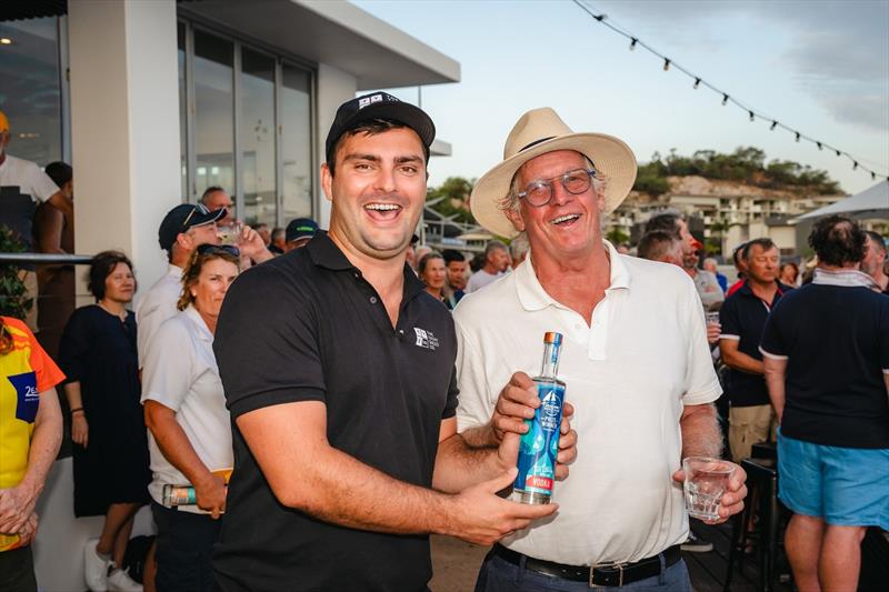 Julian Bethwaite (in hat) collects from Peter Austin after winning Race 4 - SeaLink Magnetic Island Race Week 2024 photo copyright Revolution Productions, SMIRW taken at Townsville Yacht Club and featuring the IRC class