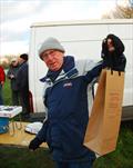 Brass Monkey Christmas race at Abbey Meads - hard-working Race Officer Martin Crysell receiving his reward © Roger Stollery