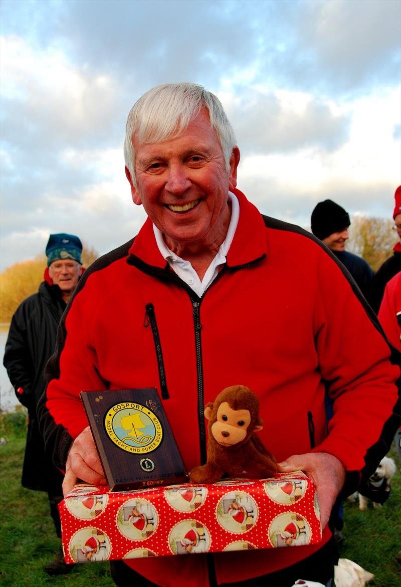 Brass Monkey Christmas race at Abbey Meads - a delighted Phil Holliday collecting his prize and the Brass Monkey - photo © Roger Stollery