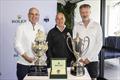 Master Lock Comanche co-skippers Matt Allen and James Mayo and LawConnect owner and skipper Christian Beck standing in front of the trophy for the overall winner, Rolex timepiece and Line Honours trophy  © CYCA | Andrea Francolini