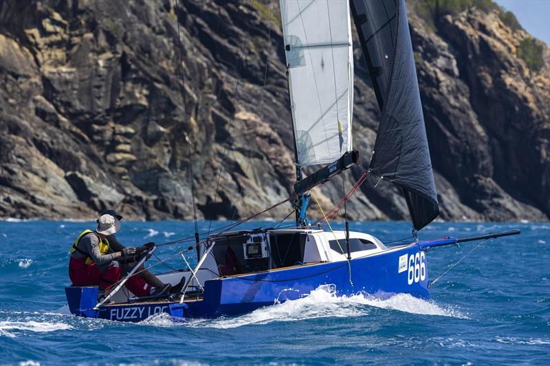 Fuzzy Logic against rocky background - 2024 Ocean Dynamics and Mount Gay Airlie Beach Race Week photo copyright Andrea Francolini / ABRW taken at Whitsunday Sailing Club and featuring the Sportsboats class